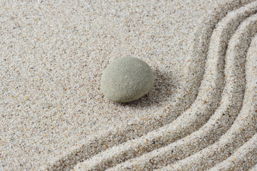 Fototapeta na wymiar Zen stone with sand as a background