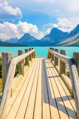 Majestic mountain lake and small wooden bridge in Canada.