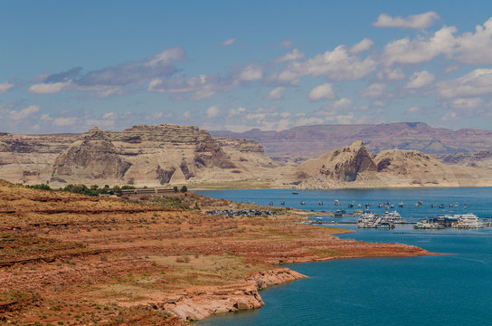 Overlooking a sunny day at Lake Powell with many boats and canyon in the background - Powered by Adobe