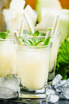 Cool summer juice of melon with ice and mint, selective focus