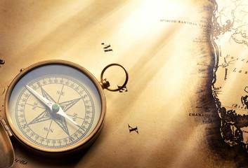 antique compass on vintage map background