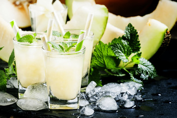 Cool summer juice of melon with ice and mint, selective focus