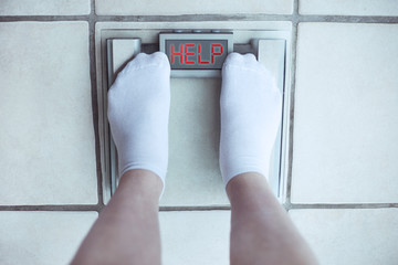 Woman's feet on bathroom scale. Diet concept