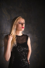 Fototapeta na wymiar blond woman in a long black evening dress