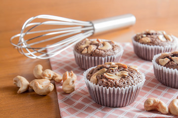 Cup of Brownies With Cashew nuts On Wooden Background
