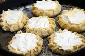Image of curd tarts in frying pan before baking