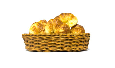 Golden brown croissant in rattan basket isolated on white background