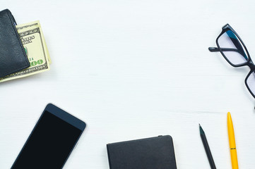 Classic men's accessories: wallet, dollars, phone, notebook, pen, glasses. Mens everyday objects on...