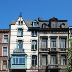 Fototapeta na wymiar Eclectic old buildings and architectural details, such as windows, attics, balconies in the city of Liege, Belgium.