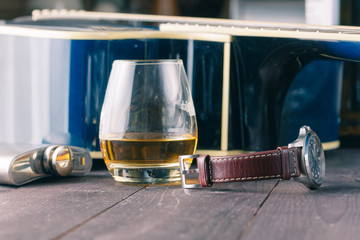 Guitar and glass of alcohol on table