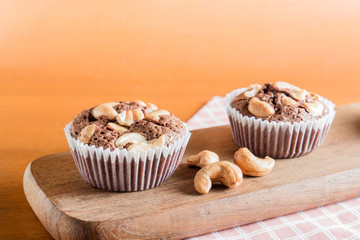 Cup of Chocolate Cake Brownies With Cashew nuts On Wooden Backgr