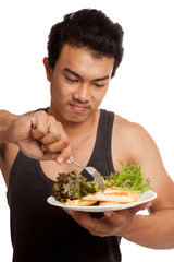 Muscular Asian man eat clean food