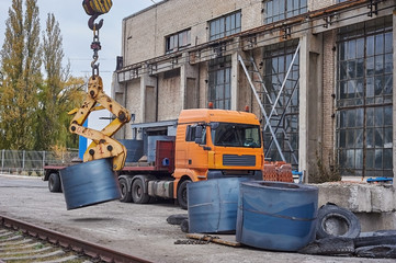 Fototapeta na wymiar Cranes unloading a freight transport with still rolls