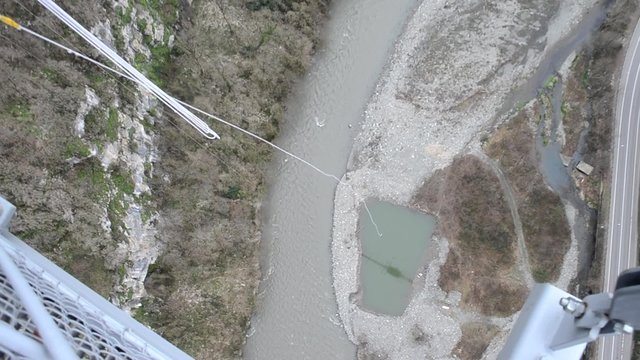 Ropejumping from the suspension bridge in mountains