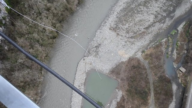 Ropejumping from the suspension bridge in mountains