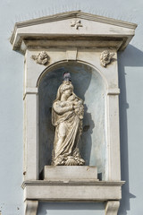 Virgin Mary statue on  stone wall in Piran, Slovenia