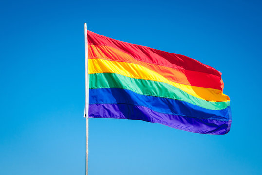 Rainbow Gay Pride Flag on blue sky backgrond