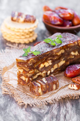 Date  walnut wedge with multigrain crackers on wooden table