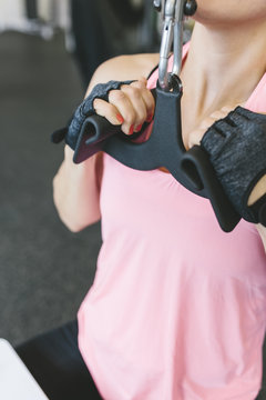 Woman doing lat pulldowns in gym