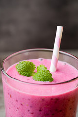 Smoothie, pink juice on the grey  background.