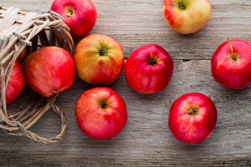 Ripe red apples on wooden background.