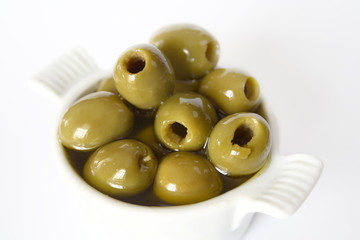 Green olives with olive oil in small bowl