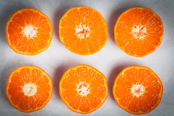 Halved juicy mandarins closeup.