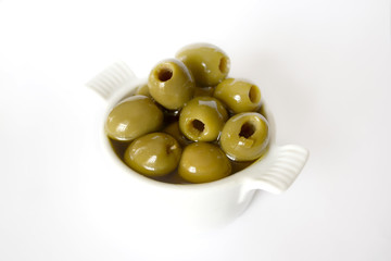 Green olives with olive oil in small bowl