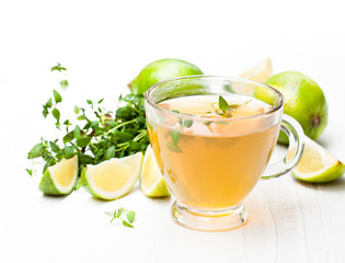 Green  tea with thyme and lime on white background