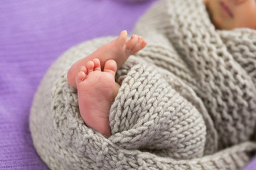 Cute feet of a newborn girl