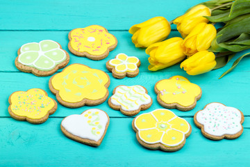 Homemade baked gingerbread and tulips on wooden background