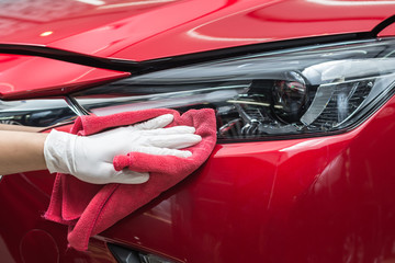Car detailing series : Worker cleaning red car