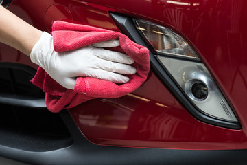 Car polishing series : Worker cleaning red car