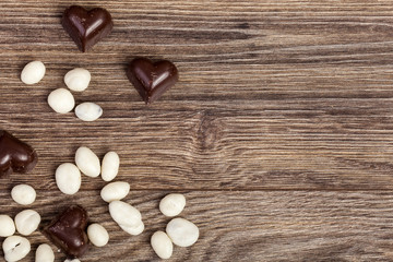 Fototapeta na wymiar Heart shaped chocolate on vintage wooden background