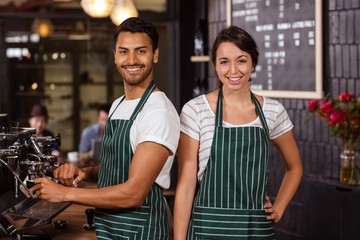 Smiling baristas working in the bar