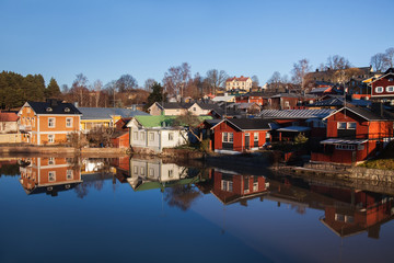 Fototapeta premium Porvoo, Finland. Classic old wood houses and their reflection in river