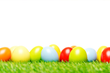 Fototapeta na wymiar Easter eggs on grass and white background as macro