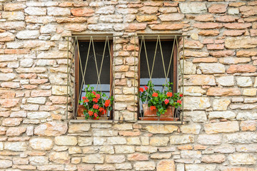Fototapeta na wymiar Beautiful window decorated with flowers in italy