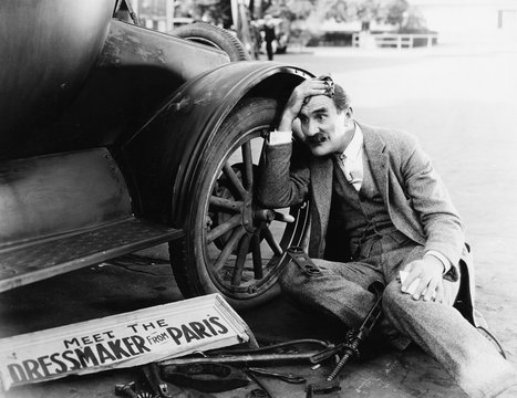 Man Trying To Fix Broken Car 