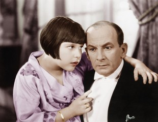 Fototapeta premium Father and daughter talking to each other in a living room 