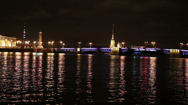 Night view of the University embankment of St. Petersburg through the Neva River- Peter and Paul fortress, Palace bridge, Vasilievsky island