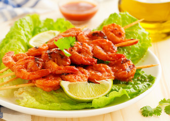 Delicious shrimp on skewers with barbecue sauce.