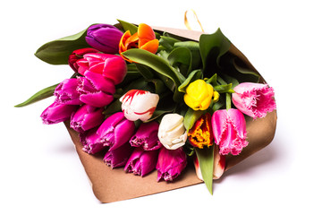 Bouquet of spring multicolor tulips flowers wrapped in present paper  isolated on white background