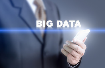 Businessman pressing hand BIG DATA message on virtual screen. Can bring to the medium of your ad.