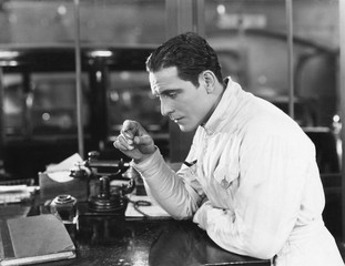 Profile of a man starring a telephone 