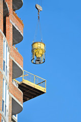 Crane lifting cement mixing container