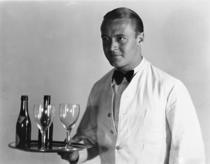 Waiter with beverages on tray 