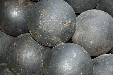 A pile of old black iron cannon balls