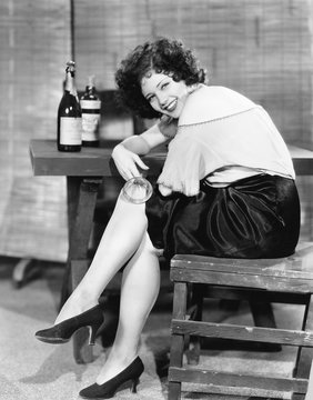 Woman in a bar looking over her shoulder and laughing 