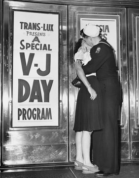 U.S. Sailor And His Girlfriend Celebrate News Of The End Of War With Japan In Front Of The TransLux Theatre In New York's Time Square, August 14, 1945 